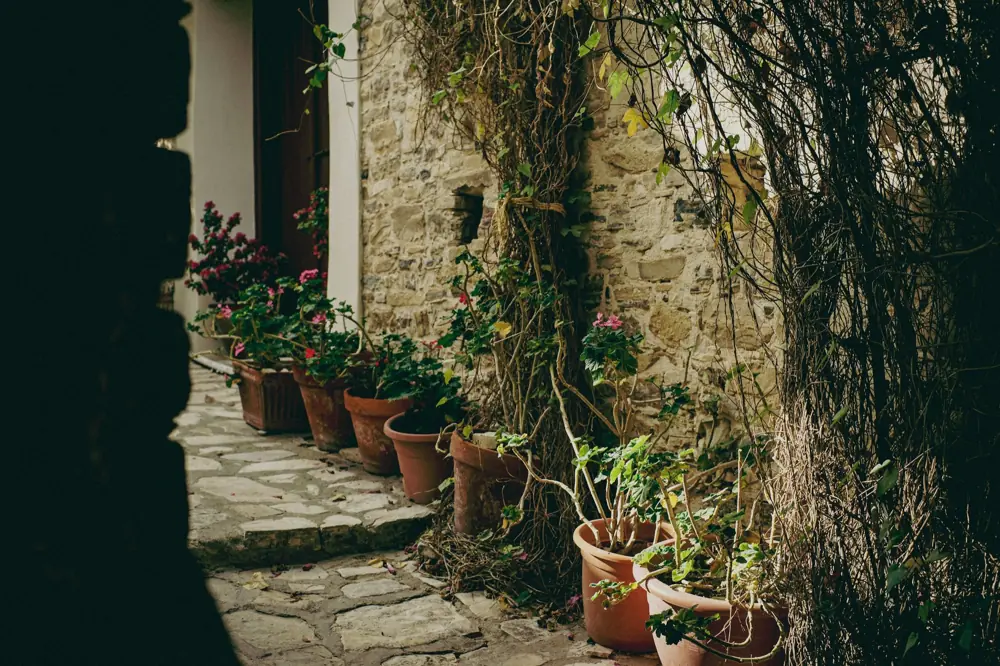 Clay flower pots by a stone wall in Lefkara